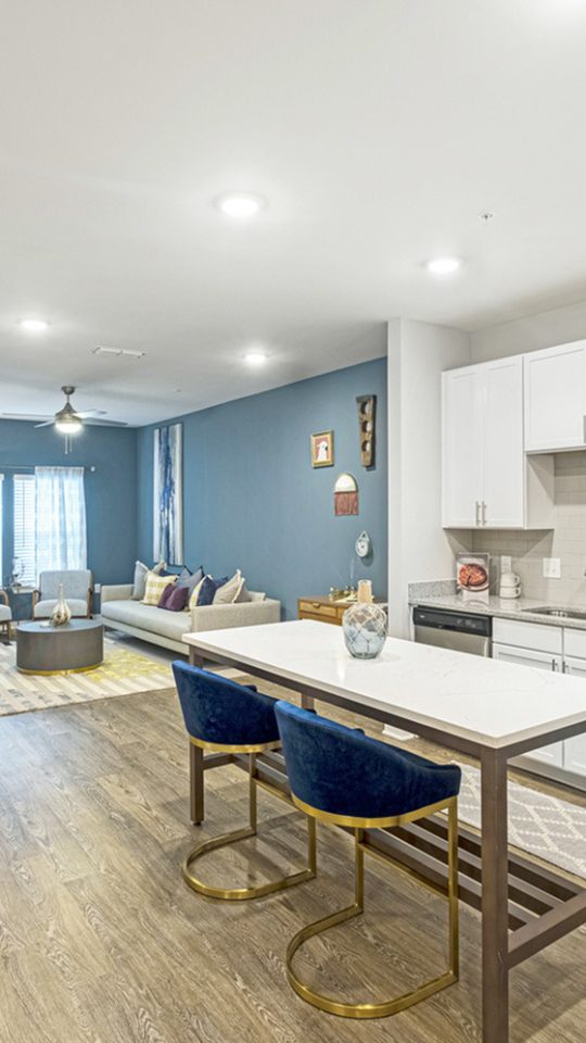 a kitchen with white cabinets and blue counter tops at The Novo Sweetwater